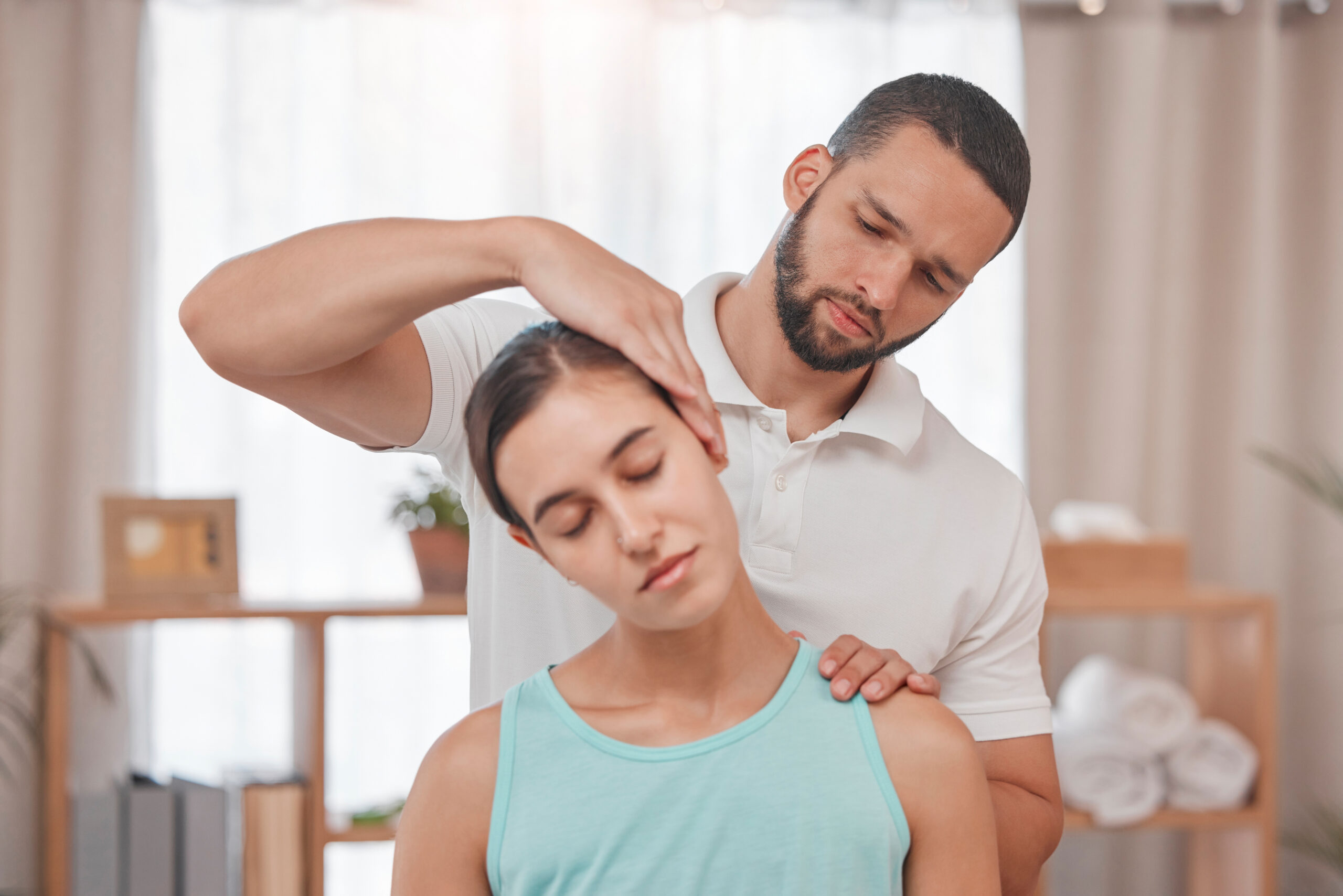 Physiotherapy, neck injury and woman in a consultation room with physiotherapist man for spine, bac.